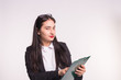 © satura_ - Young business woman wearing glasses, holding paper folder on white background