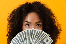 Woman Posing Isolated Over Yellow Background Holding Money Covering Face.