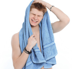 young man with towel relaxing after shower.