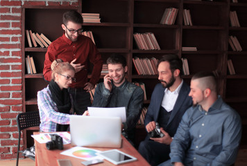 Wall Mural - creative group of designers at a working meeting in the Studio.