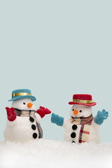 Two snowman on blue background with copy space for season greeting Merry Christmas, AF point selection