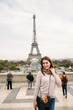 © Aleksandr - Attractive young lady stand in centre of paris. Background of eiffel tower. Travel
