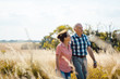 © Kzenon - Senior couple walking down a path in nature on a day in late summer