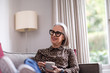 © ReeldealHD images - Mature adult female relaxing at home with a hot drink
