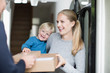 © ReeldealHD images - Young family receiving a home delivery
