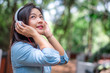 © totojang1977 - Young carefree attractive Asian woman enjoy to listening music in garden