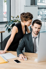 Wall Mural - young seductive businesswoman flirting with colleague during work in office