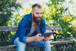 © contrastwerkstatt - Young bearded man in jeans using a tablet pc