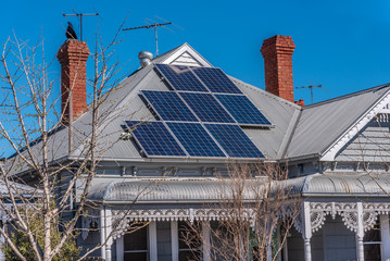 Wall Mural - Solar panels on a red roof in a suburban setting, Melbourne, Australia