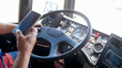 Closeup image of truck driver using smartphone while driving. Danger in transport. Irresponsible driver