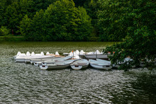 White Boats For Rent On A Lake Near A Boating Station