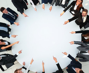 Wall Mural - closeup .business team pointing in the center of the table.