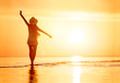 © cppzone - Lady's silhouette with raised arms sunset beach