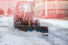 Blue Bulldozer Cleans The Streets After A Heavy Natural Snowfall. Getting Ready For Christmas. Sunny Frosty Day