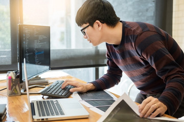 Pensive programmer working on on desktop pc programming code technologies or website design at office Software Development Company