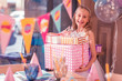 © zinkevych - Gift boxes. Cheerful emotional girl wearing beautiful clothes and smiling while standing with her presents