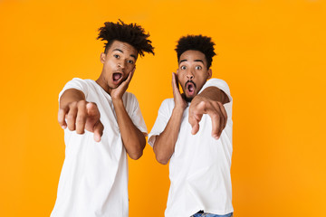 Canvas Print - Two excited male african friends in t-shirts standing