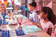 © zinkevych - Kids at the table. Pretty little kids attending the birthday party and smiling while sitting at the table