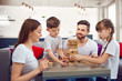© Studio Romantic - Happy family playing board games at home. Mother, father and children play together.