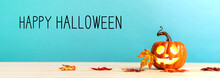 Happy Halloween Message With Pumpkin With Leaves On A Blue Background