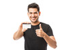 © AntonioDiaz - Smiling Young Man Holding Credit Card While Gesturing Thumbs Up