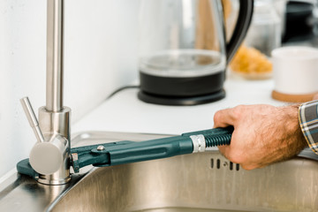 Wall Mural - cropped image of plumber repairing tap with monkey wrench in kitchen