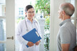 © DragonImages - Pretty Asian doctor standing in doorway of aged senior patient
