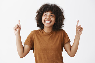 Wall Mural - girl happily looking at sky enjoying nice summer weather. portrait of attractive dreamy african amer