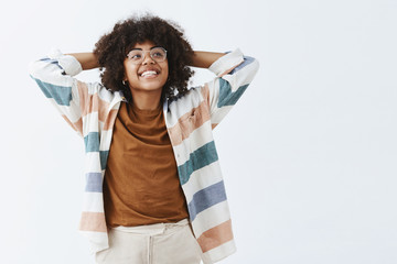 Wall Mural - waist-up shot of carefree good-looking and stylish female entrepreneur in glasses holding hands behi