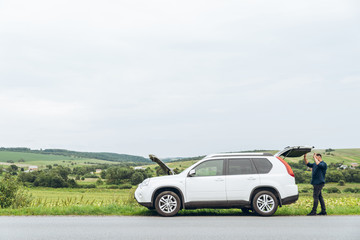 Wall Mural - man with broken car at road side