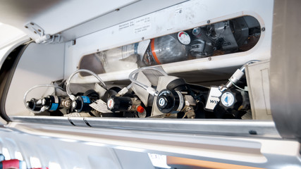 closeup photo of oxygen cylinders in emergency case on modern jet airplane