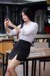 © tiniroma - Portrait of thai adult office girl using her smart phone Selfie