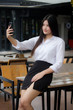 © tiniroma - Portrait of thai adult office girl using her smart phone Selfie