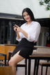 © tiniroma - Portrait of thai adult office girl using her smart phone