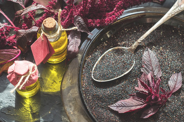 Bottles with amaranth oil, plants and amaranth seeds