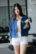 © tiniroma - Portrait of thai adult beautiful girl blue jeans in fitness relax and smile