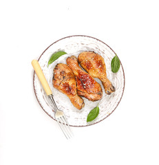 grilled chicken legs with sesame  in a  plate on a white background