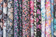 © Gribanov - Samples of fabric - printed cotton of different colors with flowers on the display case