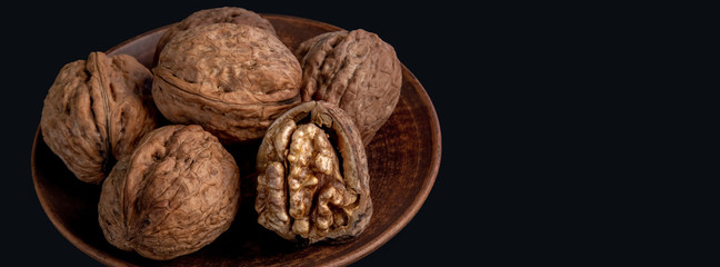 Wall Mural - large walnuts on black background