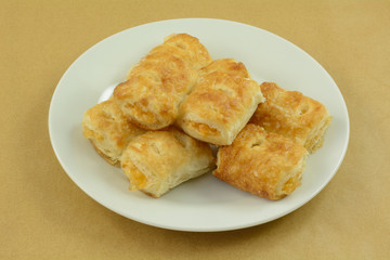 Wall Mural - Stack of mini apple breakfast turnovers on white plate on table