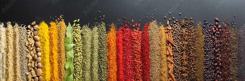 Colorful collection spices and herbs on background black table. Mediterranean condiments for decorating packing with food. - obrazy, fototapety, plakaty 