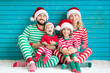 © Sunny studio - Happy family having fun at Christmas time