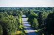Panoramic view of the asphalt road through the green forests, Estonia