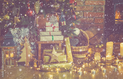 Stack Of Presents Under Lit Up Christmas Tree With Baubles And