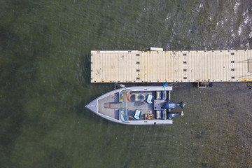 Wall Mural - Aerial birdseye view of a speed boat at a pier.