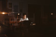 © mavoimages - Young Asian businessman working overtime alone in a dark office