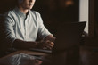 © mavoimages - Businessman using a laptop in an office late at night