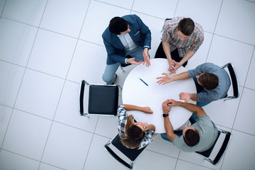 Wall Mural - top view.Manager and creative team sitting at the round table