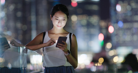 Wall Mural - Woman use of mobile phone in city at night