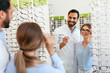 © puhhha - Eye Doctor With Woman Choosing Eyeglasses At Glasses Store